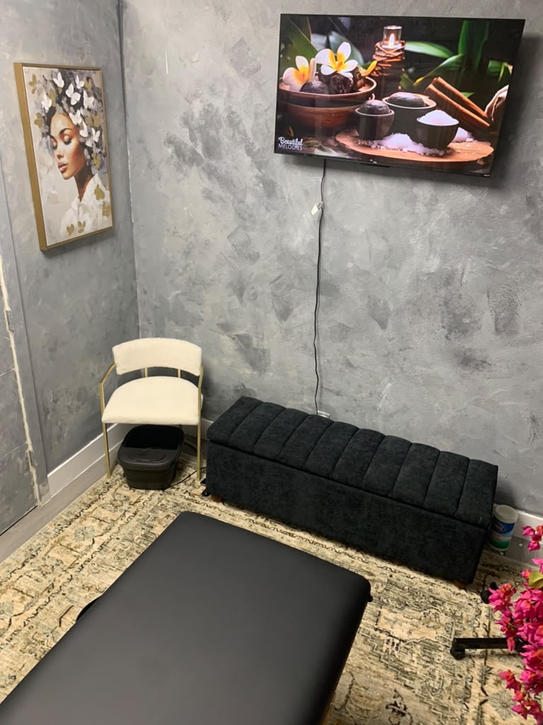 Professional facial treatment space at Paradise Within with a treatment table and calming spa artwork