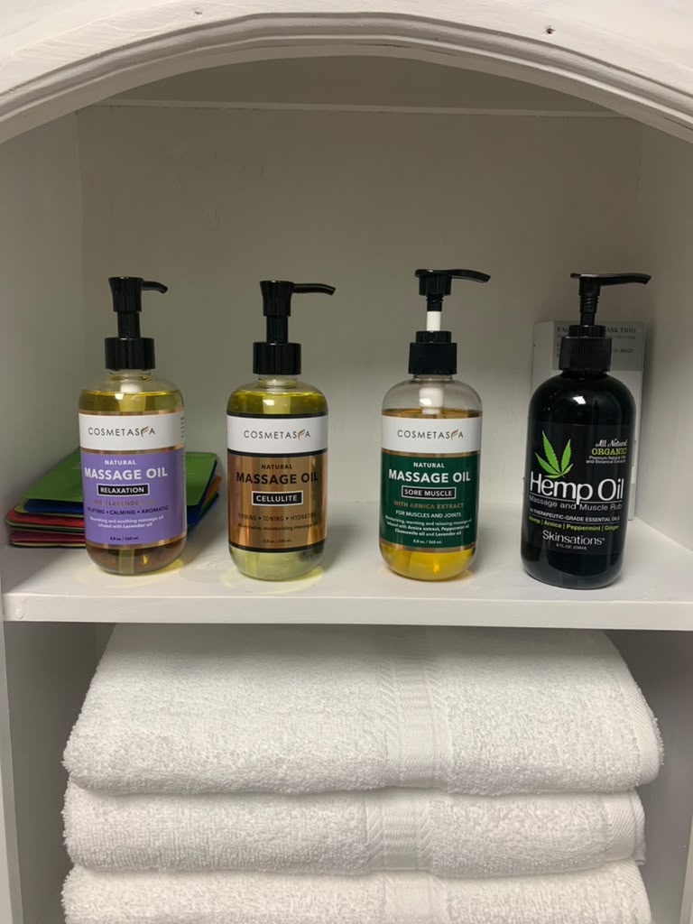 Massage oils displayed with fresh spa linens